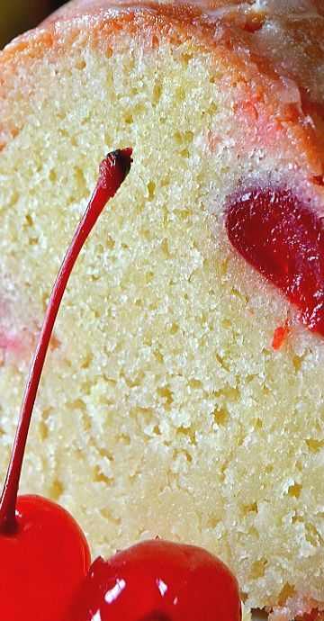 a close up of a piece of cake with cherries on it