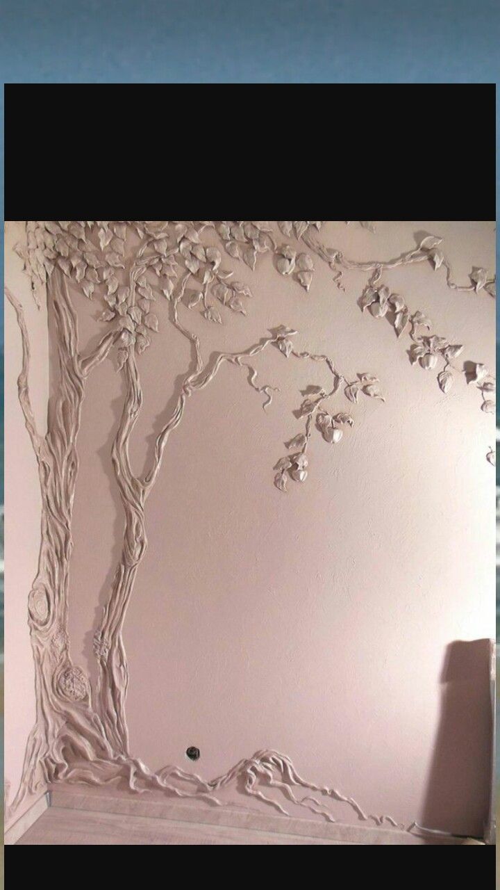 a white wall with a tree painted on it