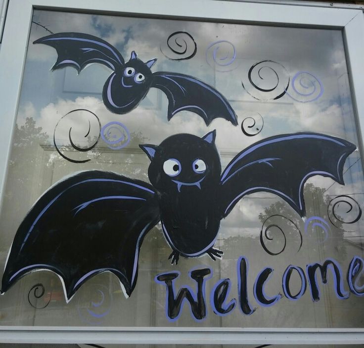 a welcome sign with bats painted on it