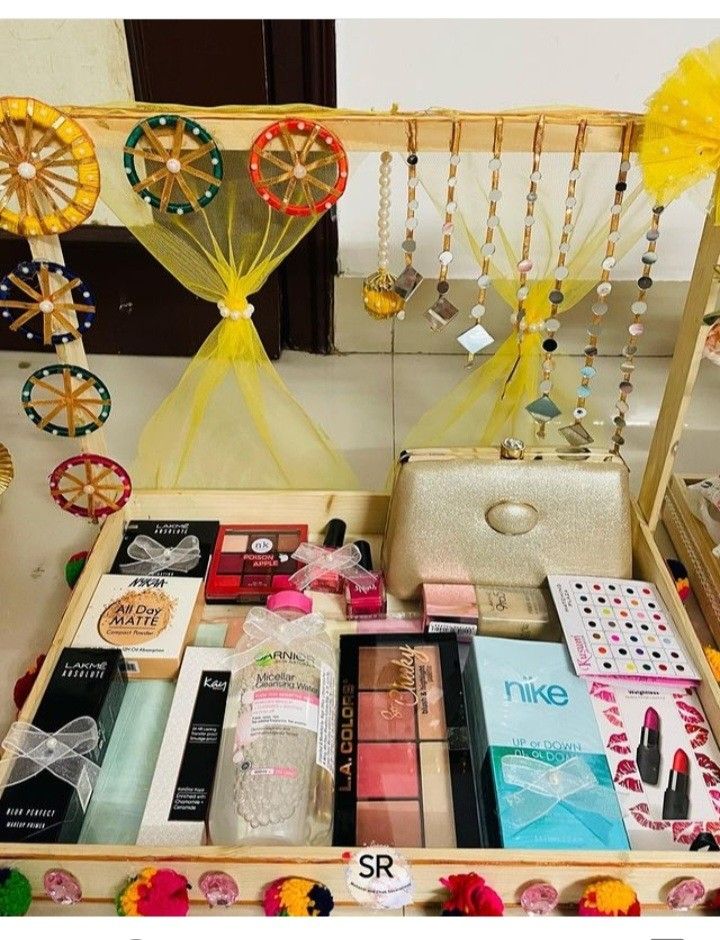 an open drawer with various items in it and some decorations hanging from the ceiling above