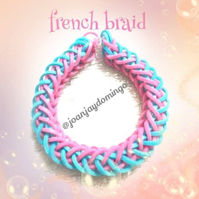 there is a pink and blue braided bracelet on the white background with water droplets