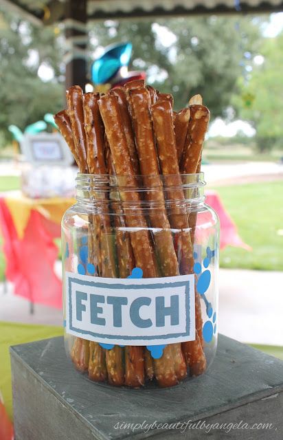 a jar filled with lots of pretzels sitting on top of a table