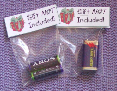 two small batteries are wrapped in plastic and have tags on them that say, gift net included