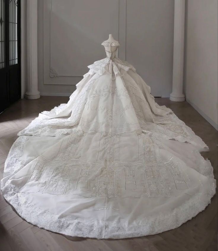 a white wedding dress on display in a room