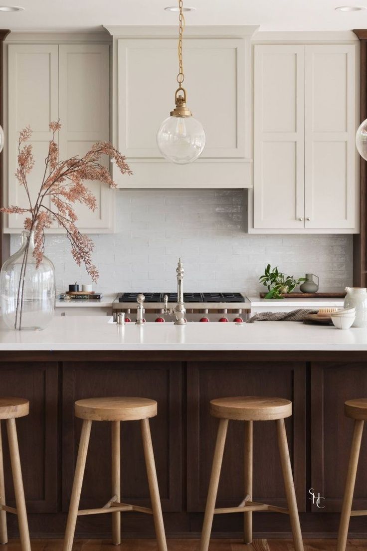 three stools sit in front of a kitchen island