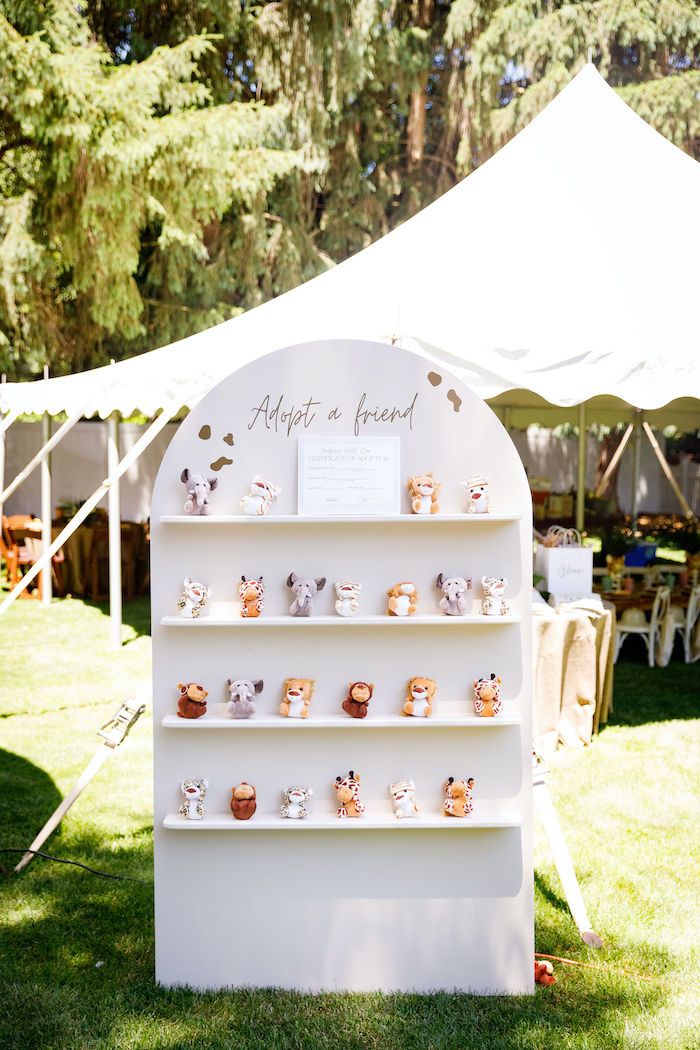 there are many small cupcakes displayed on the shelf in front of the tent