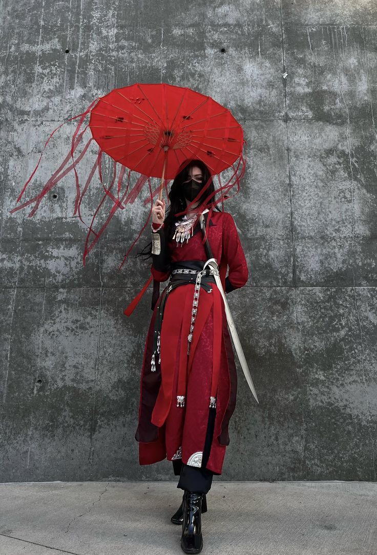 a woman dressed in red holding an umbrella