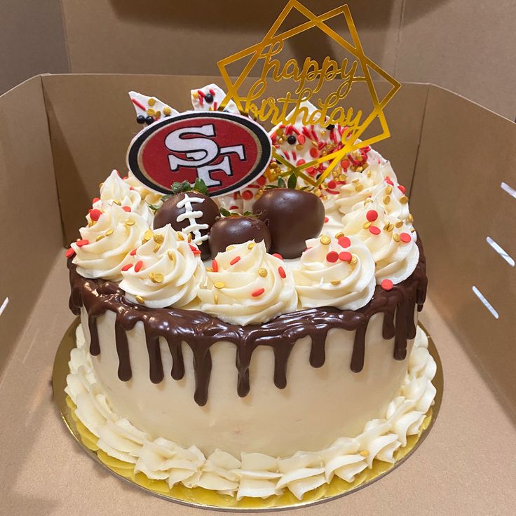 a san francisco giants birthday cake with white frosting and chocolate drizzles