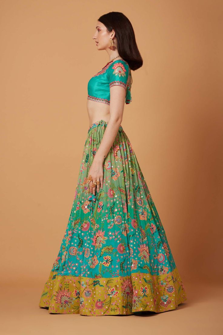 Editor's Note Aqua Turquoise Ombre Hand Embroidered Lehenga Set With SB Signature Wild Flower Print, Sunkissed Yellow Suede Velvet Embroidered Border and Silk Organza Embroidered Scallop Dupatta. Fabric: Dupion, Pure Crepe, Silk Organza, Suede Velvet Color: Aqua Turquoise Care: Dry Clean Only Disclaimer: Product Color May Slightly Vary Due To Photographic Lighting Sources Or Your Monitor Setting. About the Designer Siddhartha Bansal, label epitomise its design philosophy touring around " Golden Siddhartha Bansal, Scallop Dupatta, Turquoise Ombre, Embroidered Lehenga, Design Philosophy, Embroidered Border, Color Aqua, Aqua Turquoise, Velvet Color