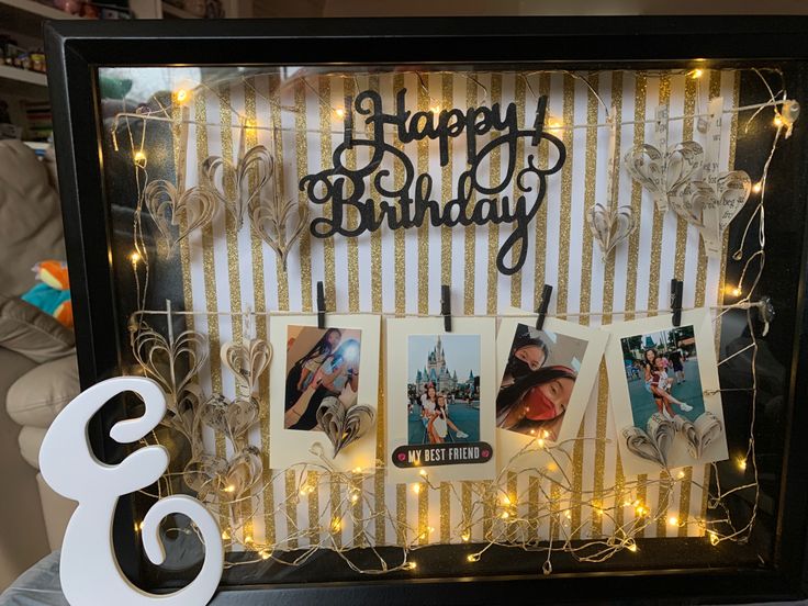 a birthday photo frame with photos and lights