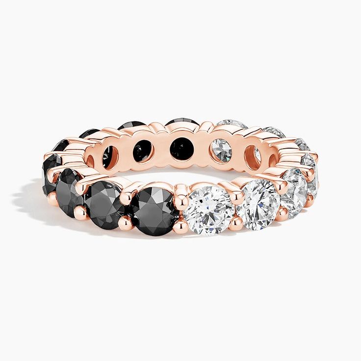 a rose gold ring with black and white stones