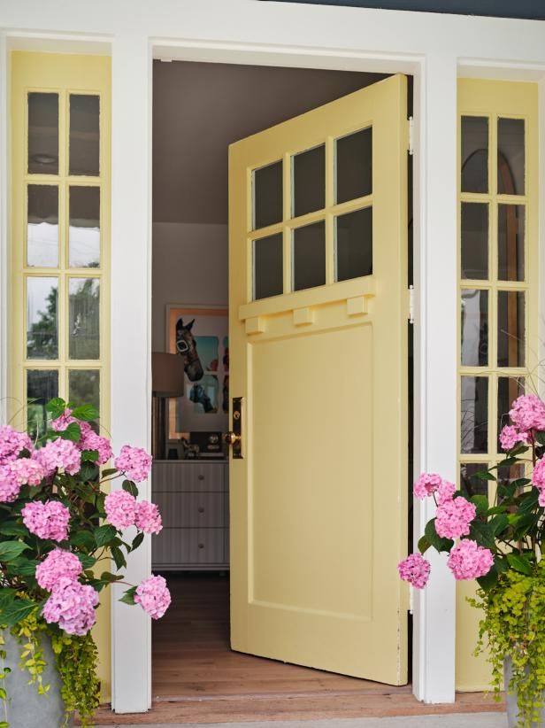 the door is open and there are pink flowers in vases