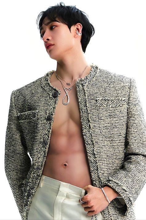 a shirtless man with no shirt wearing a jacket and white pants is posing for the camera