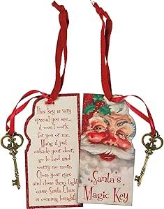 two tags with santa's face on them hanging from red ribbon and one has a key attached to it