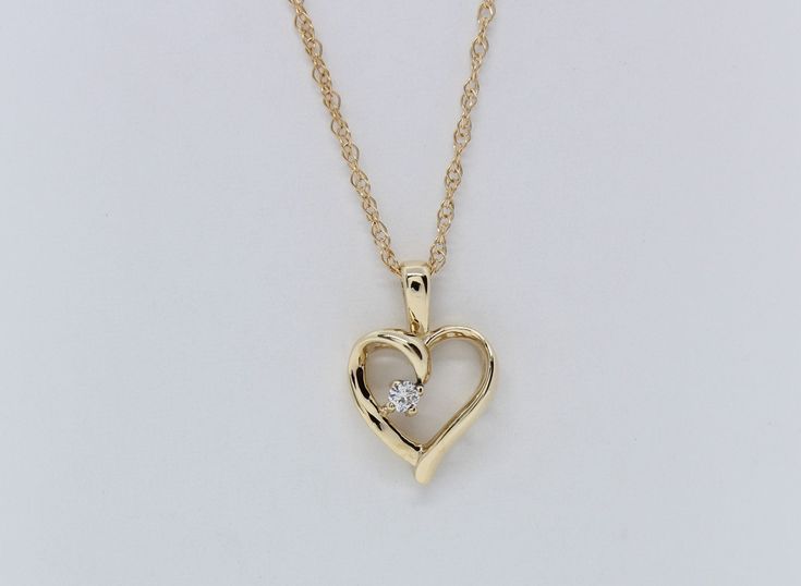 Experience the enduring charm of our 14K Yellow Gold Heart Pendant, adorned with .03 carats total weight of Lab Diamonds, and complete with an 18" Chain. This exquisite piece is skillfully handcrafted by our artisanal goldsmith at Jewelry By You. 14k Gold Heart Pendant Diamond Necklace For Anniversary, Yellow Gold Heart Pendant With Single Diamond, Heart-shaped Yellow Gold Jewelry With Single Diamond, Yellow Gold Heart Cut Jewelry With Single Diamond, 14k Gold Heart Cut Single Diamond Necklace, Valentine's Day Gold Jewelry With Single Diamond, Valentine's Day Single Diamond Gold Jewelry, Heart Pendant Diamond Jewelry Stamped 14k, 14k Gold Birthstone Necklace With Diamond Cut For Anniversary