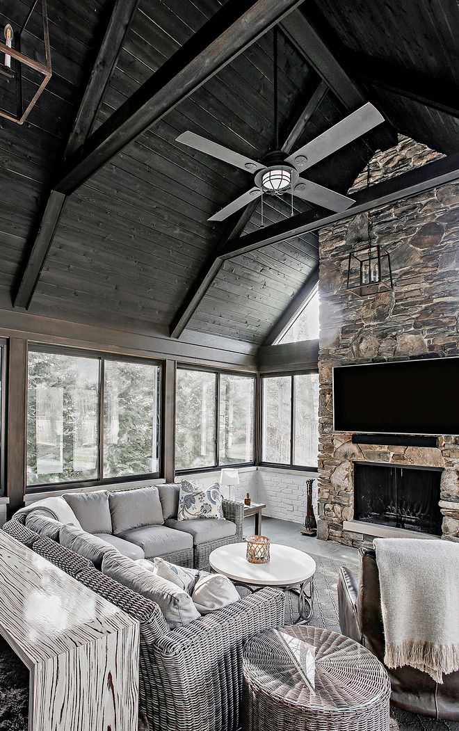 a living room filled with lots of furniture and a flat screen tv mounted to the wall