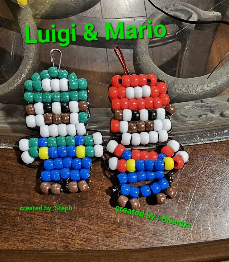 two earrings made out of beads on top of a wooden table