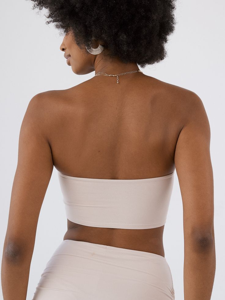 A basic essential that’s anything but basic. This ultra crop V Tube Top Brami features built-in padding and a band-less internal structure, providing coverage without needing to wear a separate bra. Designed with a V Hardware in the center bust with ruched detailing. Pair with our Ruched Mini Skort for a matching moment. Support: Low Support Fit: True to Size (Size down for a more snug fit) Fabric: 92% Modal, 8% Spandex Internal Structure: Band-Less (1) FREE Standard Signature Padding included: White Beige, Tube Top, Bra Sizes, Snug Fit, Built In, Spandex, Bra, Band, Fabric