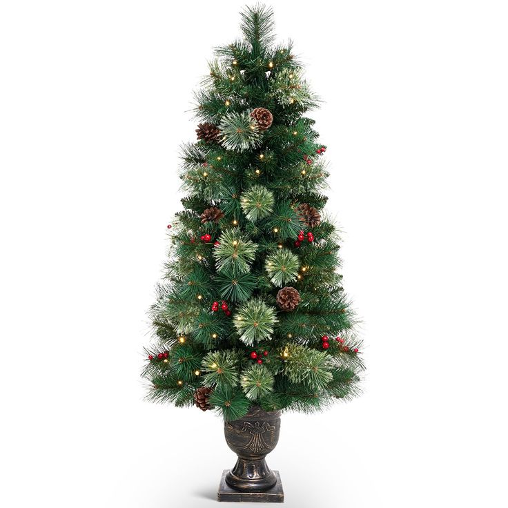 a small christmas tree with pine cones and berries in a pot on a white background