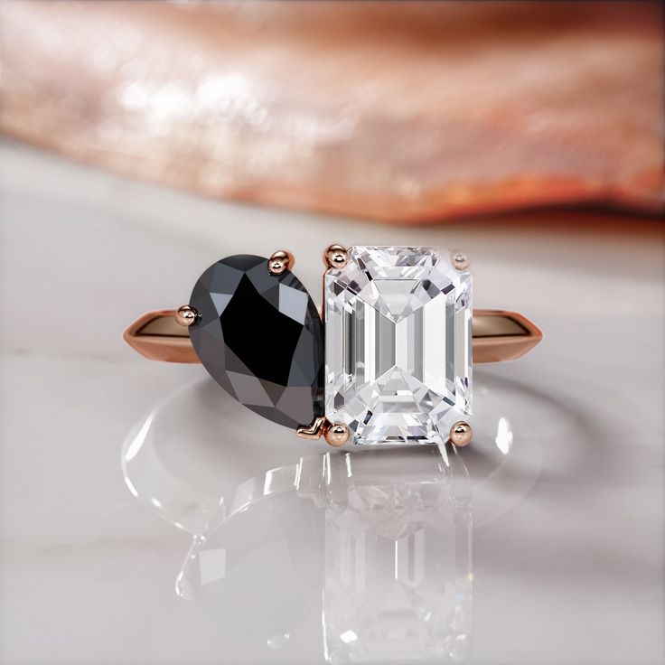 an emerald and black diamond engagement ring