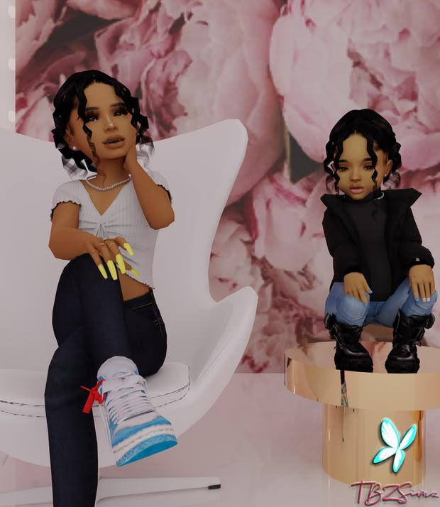 two black dolls sitting on white chairs in front of a wall with flowers and butterflies