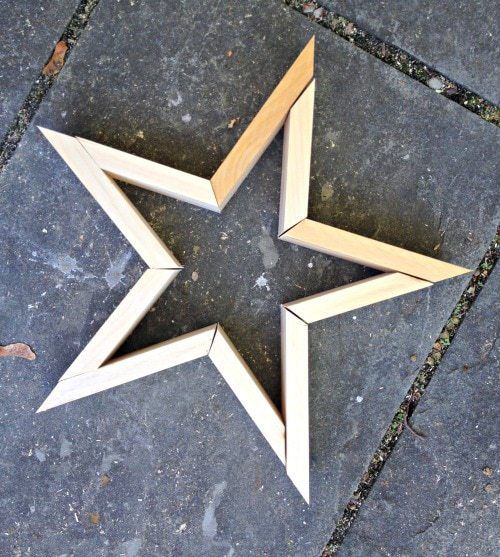 three wooden stars are placed on the ground