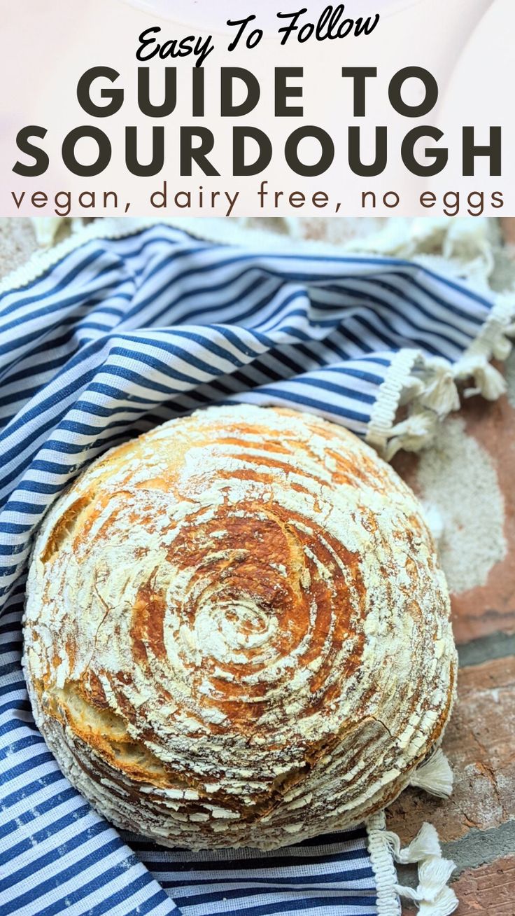 a loaf of sourdough sitting on top of a blue and white striped towel