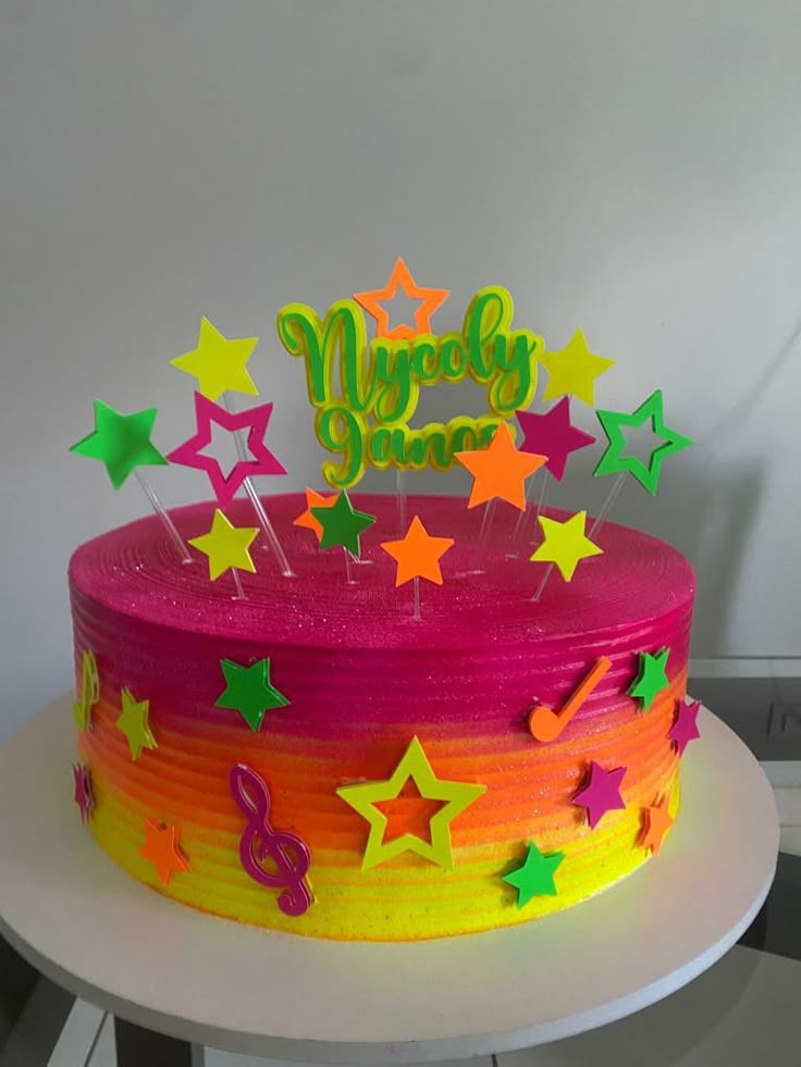 a brightly colored birthday cake with stars on it