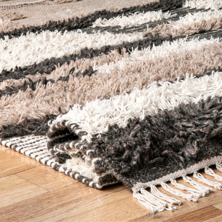 an area rug is shown on the floor with wooden floors and hard wood planks