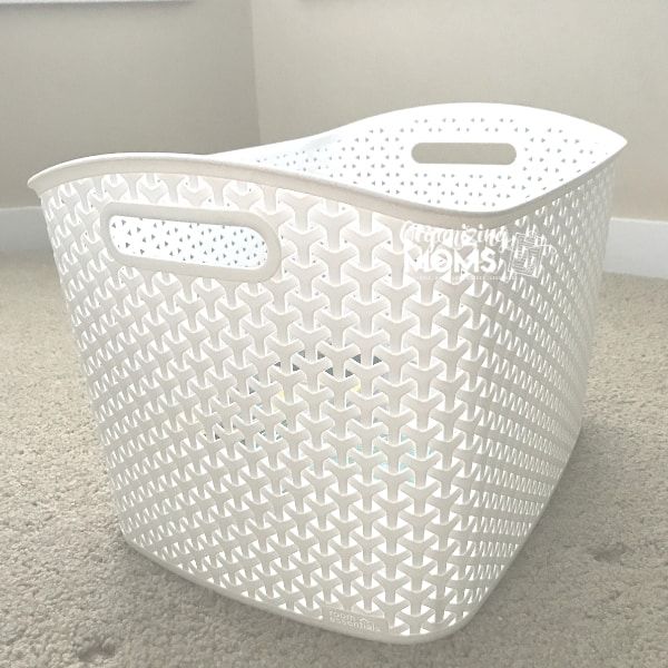 a white plastic basket sitting on the floor