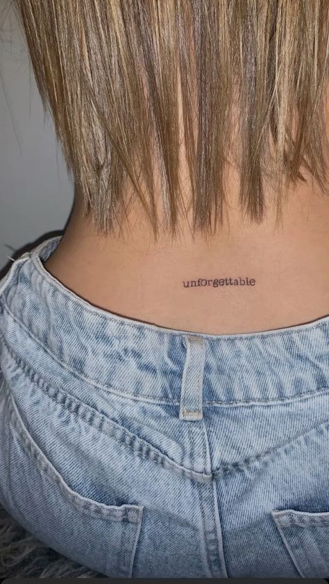 the back of a woman's neck with an unforetable tattoo on it