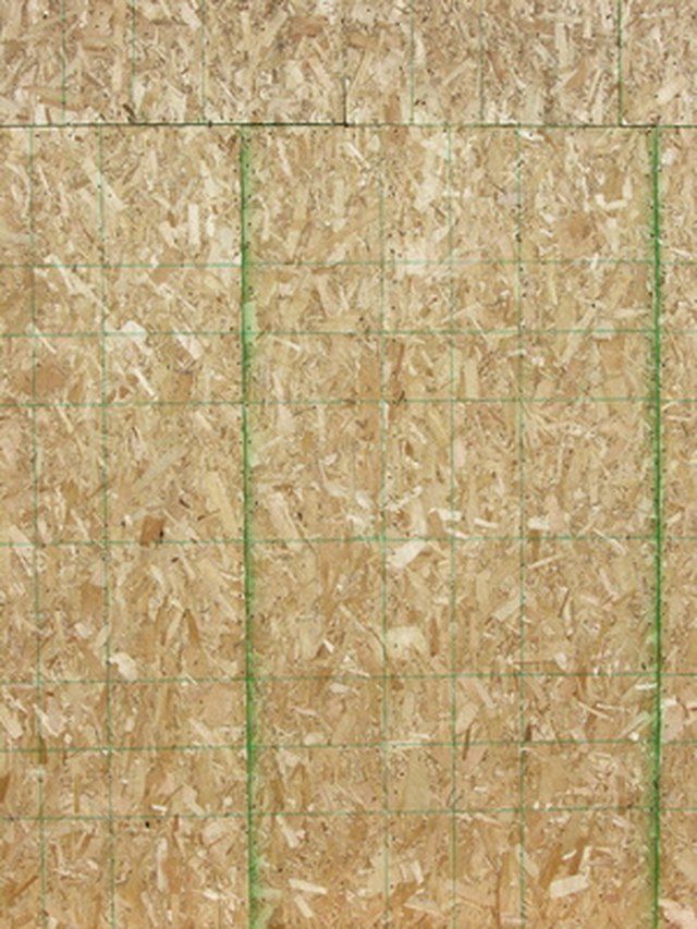 an image of a wall that is made out of plywood board and has green tape on it