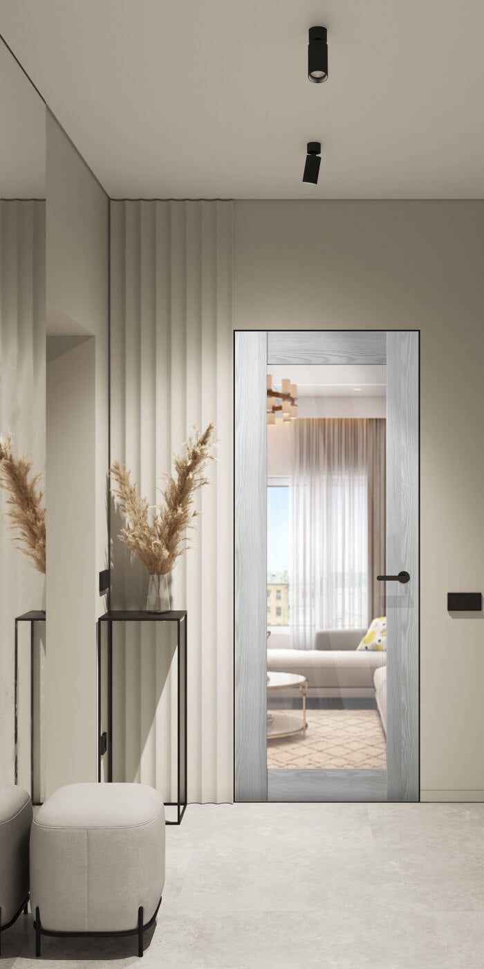 a living room with a couch, chair and large glass door leading to the bedroom