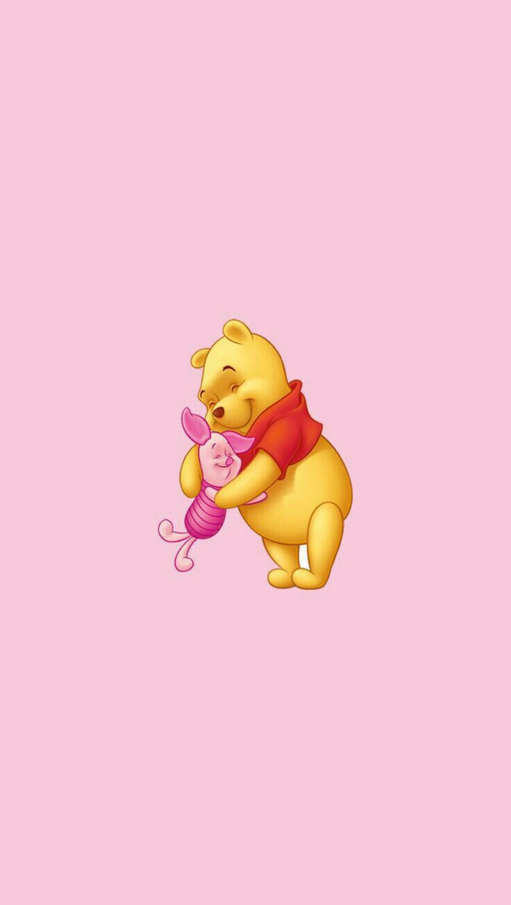 winnie the pooh holding a pink toy