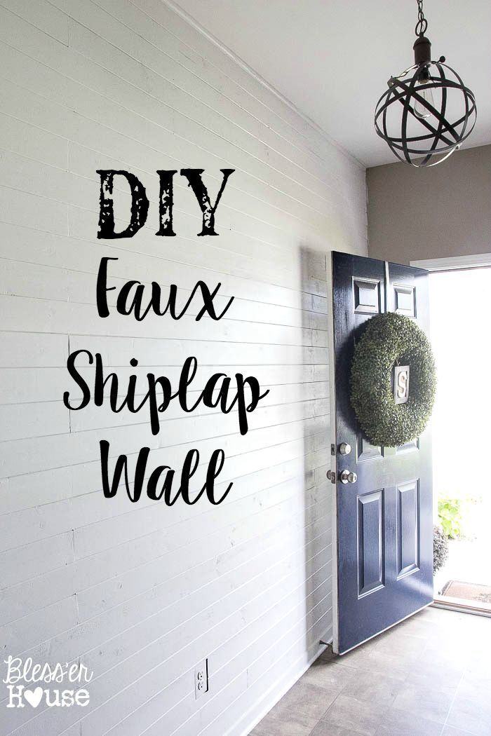 diy faux shiplap wall with the words diy on it and a wreath hanging from the front door