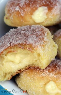 powdered sugar covered doughnuts in a white bowl