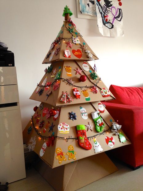 a cardboard christmas tree sitting on top of a table