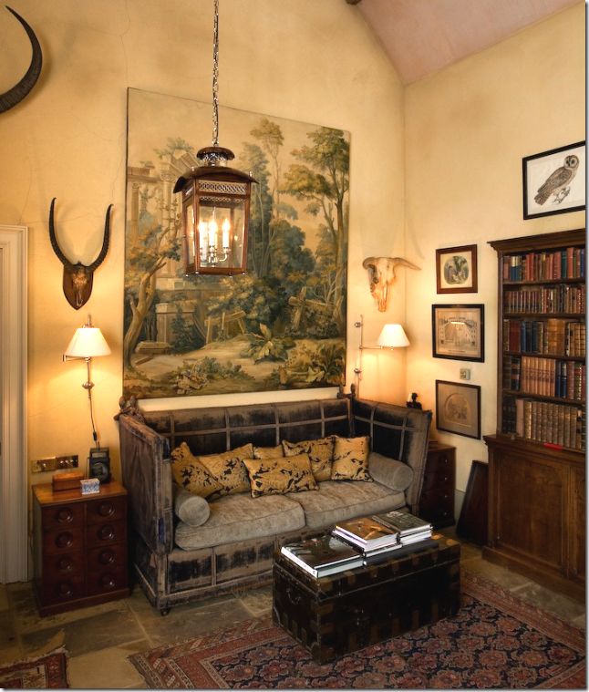 a living room filled with furniture and a painting on the wall above it's head