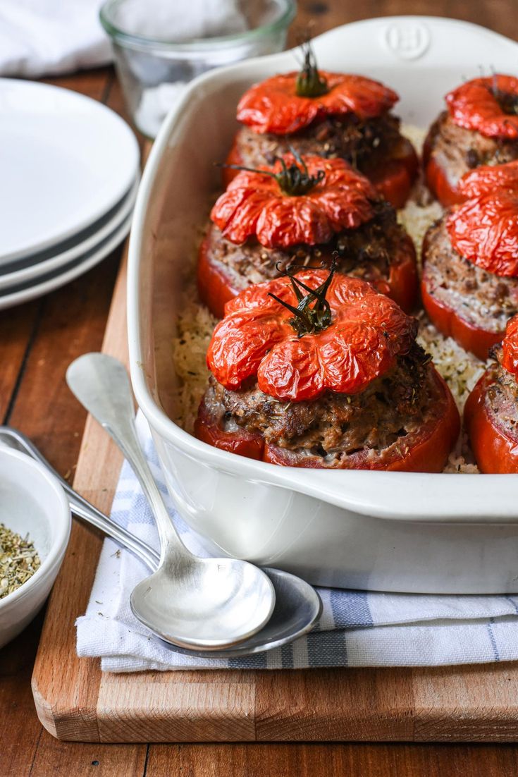 a casserole dish filled with meat and tomatoes