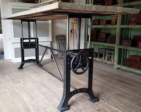 an industrial table with wheels on it in the middle of a room