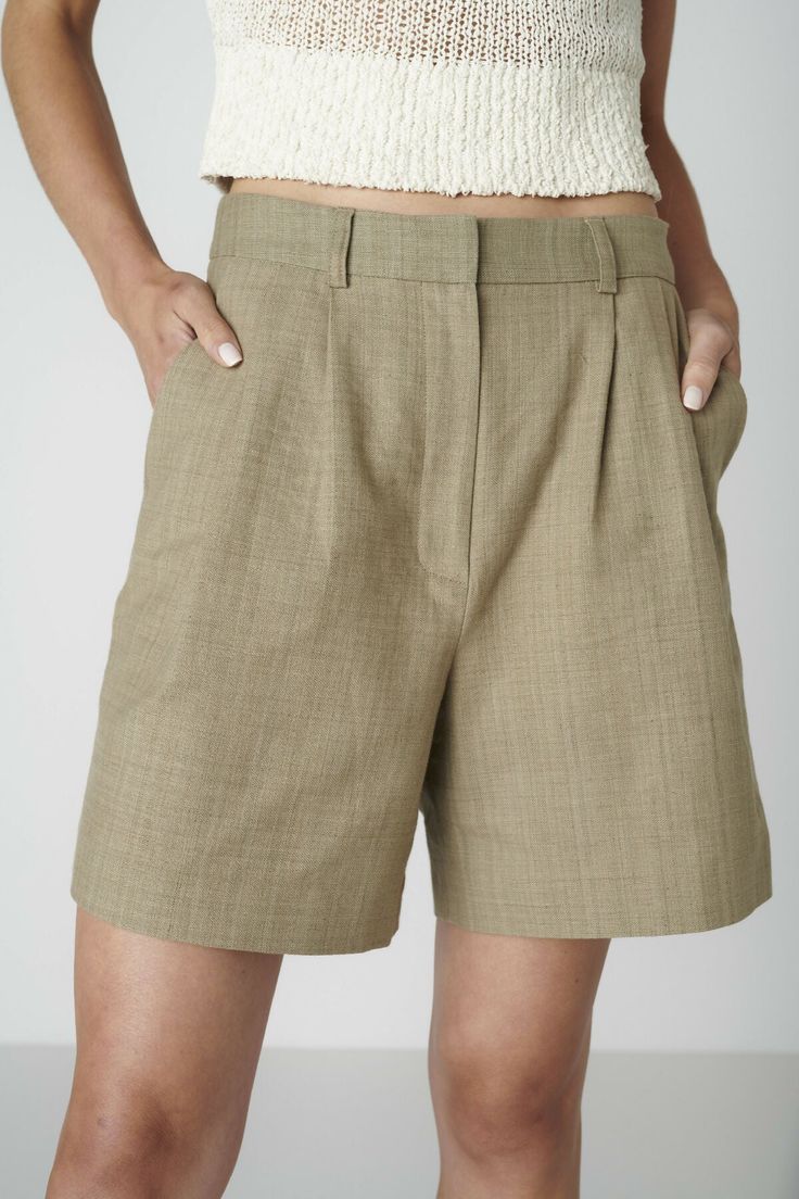 Want to look elegant and show a bit of leg? Discover the Bièl shorts in Sage Green. These shorts feature a high and slim fit at the waist, with a relaxed fit in the leg. They include a double pleat and two side pockets. The Bièl shorts are perfect for the warmer summer days, but also look stunning in the winter when paired with tights and boots. Complete your look with the matching June Jacket.The fabric is a mix of organic and recycled cotton. The yarns are traditionally plant dyed with red onions in India and then handwoven into a beautiful fabric, giving it a natural look and ensuring its uniqueness. The production is carried out by a family-owned business in Portugal.Size & FitFits true to size. Our model is 177cm (5 feet 9.7 inches) and wears size S. Material & CareThe fabric of the B Classic Bermuda Shorts With Built-in Shorts, Chic Bermuda Shorts With Belt Loops, Green Workwear Shorts With Belt Loops, Elegant Pleated Short Bottoms, Green High-waisted Shorts For Work, High-waisted Green Shorts For Work, Chic Shorts With Belt Loops And Short Inseam, Chic Shorts With Short Inseam And Belt Loops, Elegant Knee-length Bermuda Shorts With Pockets