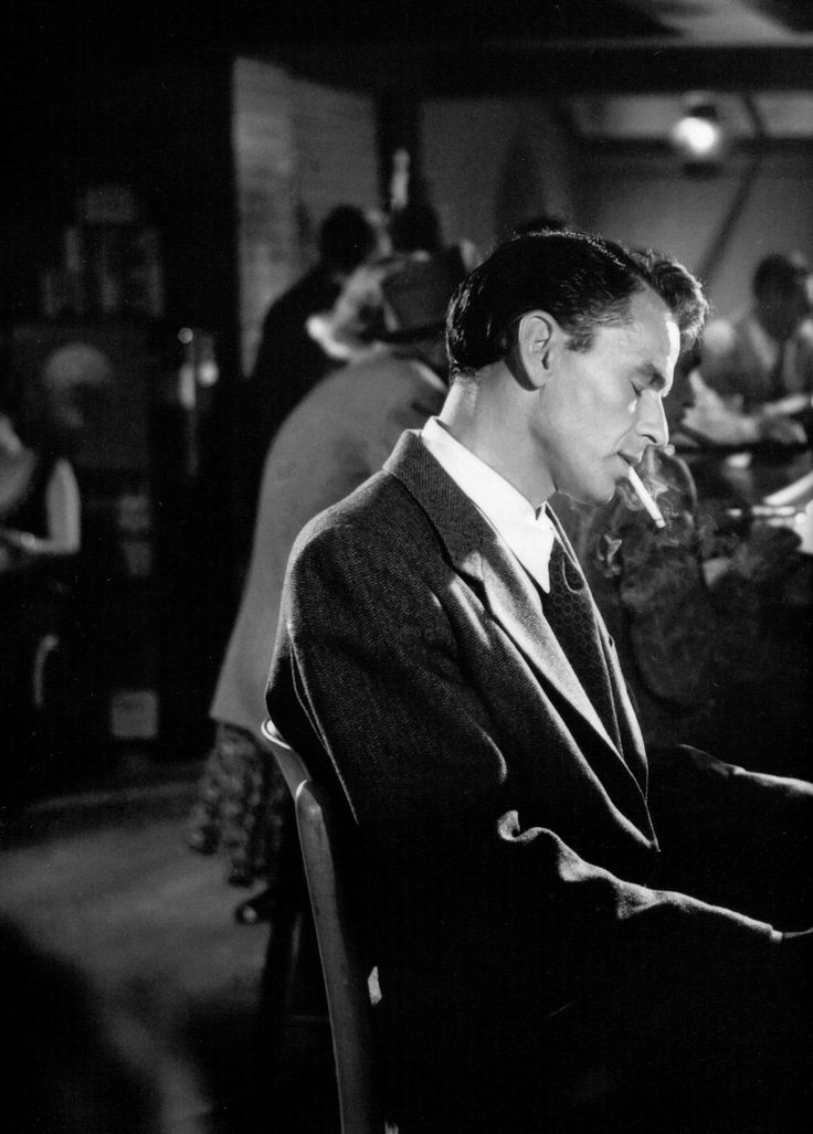 a man in a suit sitting at a table