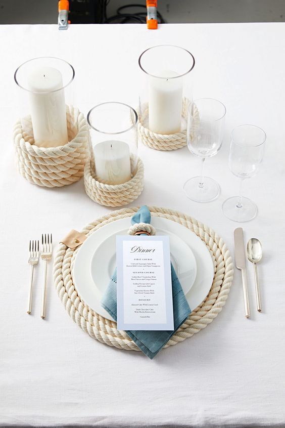 a table setting with place settings, silverware and white linen napkins on it