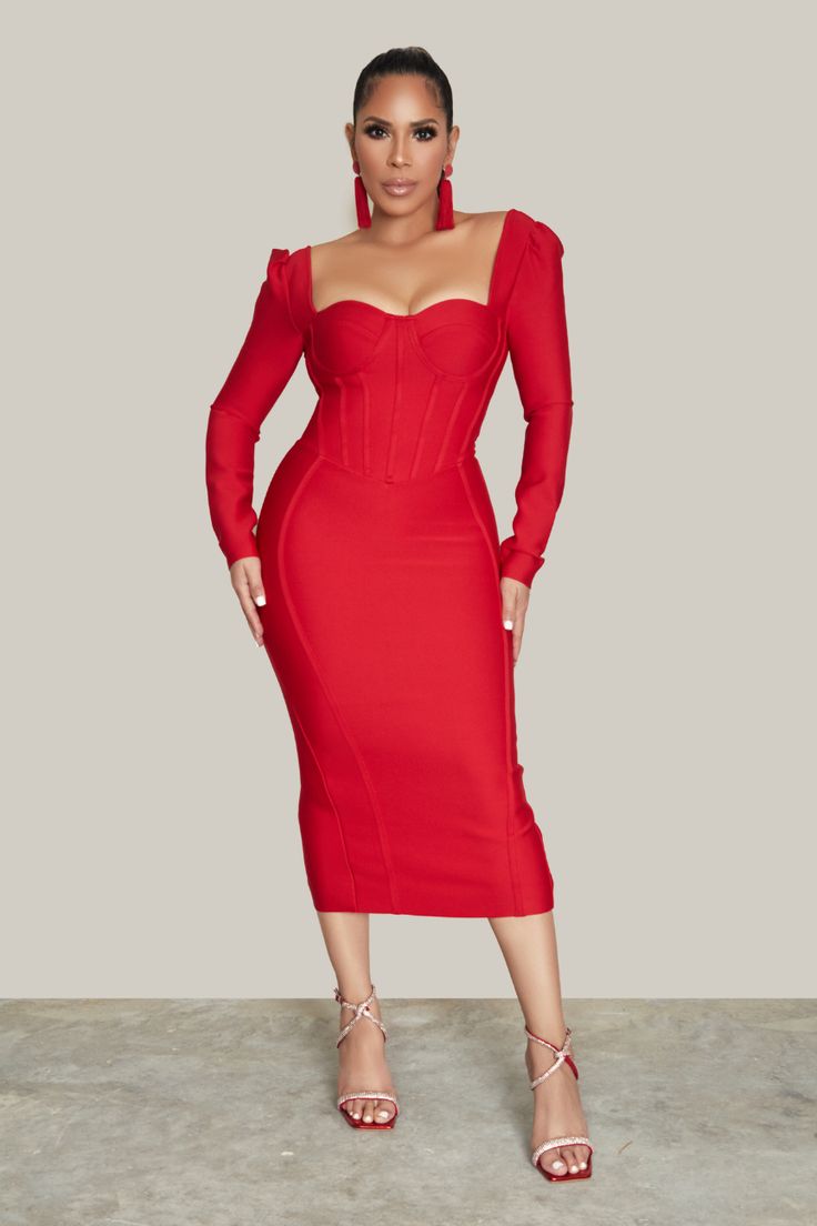 a woman in a red dress posing for the camera