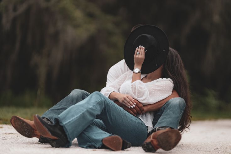 a woman sitting on the ground with her head in her hands