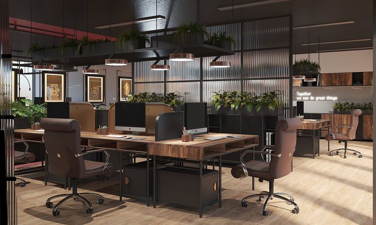 an office with lots of desks and plants on the wall, along with large windows