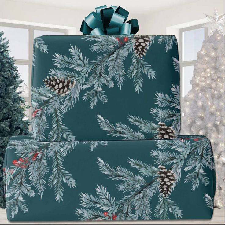 two presents wrapped in blue wrapping paper with pine cones on them