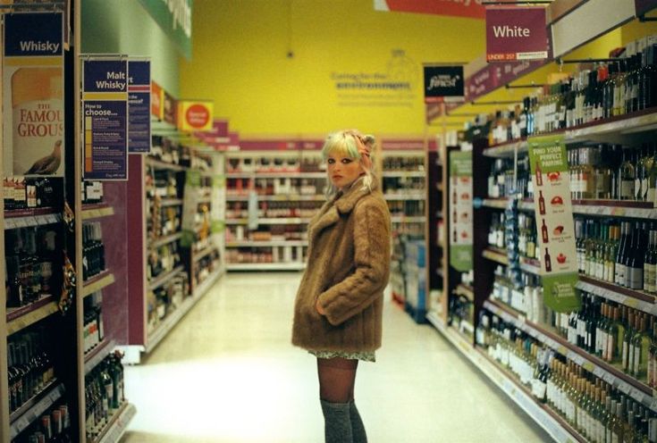 a woman is standing in the aisle of a store