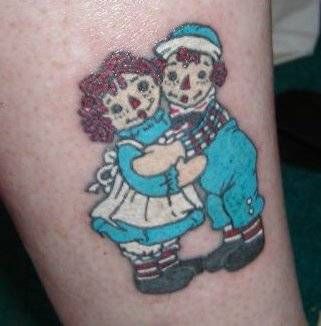 a couple of people that are hugging each other on their legs with tattoos on them