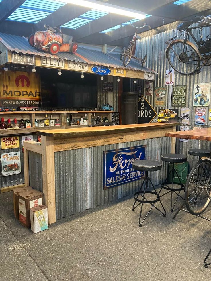 an outdoor bar with several stools and tables in front of it, along with two bicycles